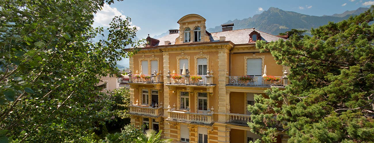 The building of Hotel Westend surrounded by trees